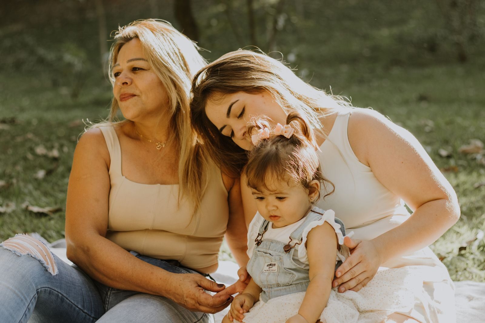 Three women of different ages enjoying a sunny day outdoors, capturing familial bonding moments.